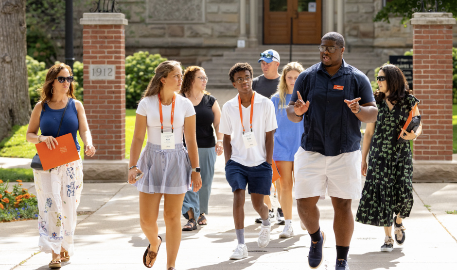A tour group walks outside around campus.