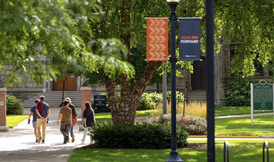 A tour group walks outside around campus.
