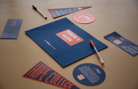 A collection of Hope Collection promotional materials on a table.