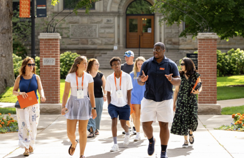 A tour group walks outside around campus.