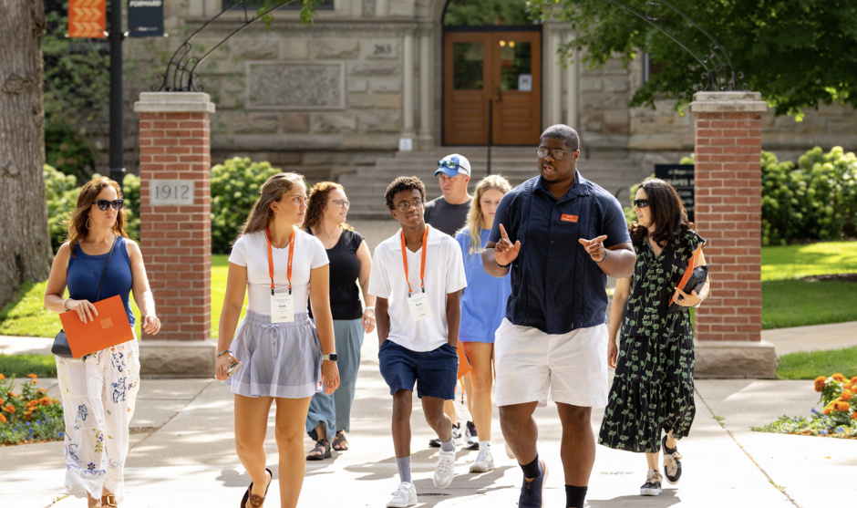 A tour group walks outside around campus.