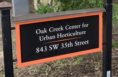 The orange-and-black sign for the Oak Creek Center for Urban Horticulture.