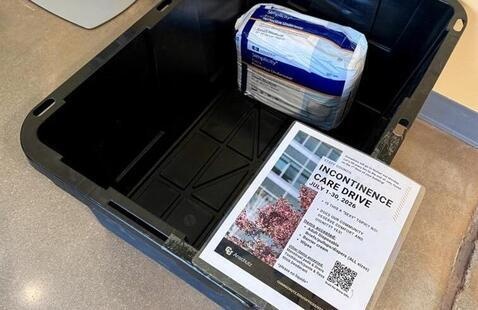 A black collection bin example that is being placed in buildings to collect items for this drive.