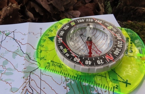 A compass placed on a map.