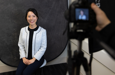 A student gets their picture taken in business casual attire.