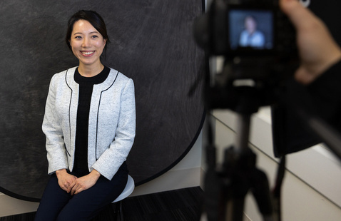 A student gets their picture taken in business casual attire.