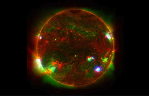 A spectroscopy image of the sun, marbled in red, green and blue.