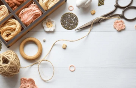 A collection of yarn and string with a pair of scissors