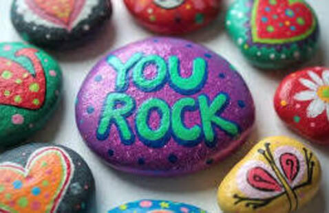 painted rocks, the center one has "you rock" painted on it