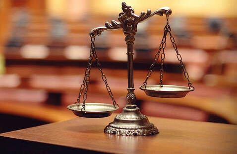 scales of justice model on a table