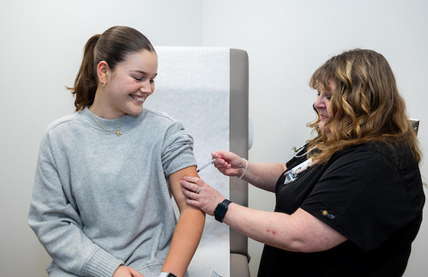 A nurse administering a vaccine to a student in the Student Services Clinic.