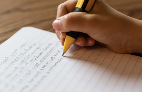 Writing in a notebook.