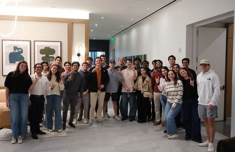 Group of UT students with Hook'em hands