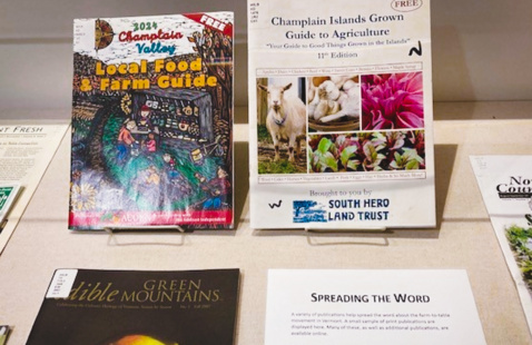 A shelf holds books and pamphlets related to local farming.