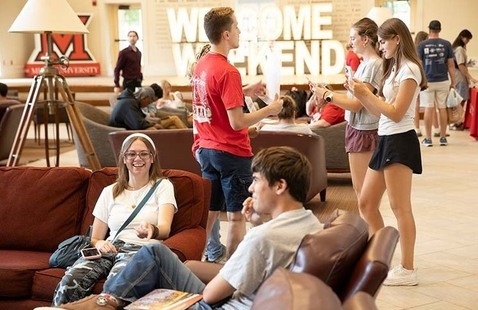 Students in Armstrong Student Center lounge and large light up letters spell Welcome Weekend 