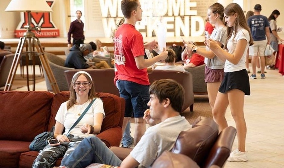Students in Armstrong Student Center lounge and large light up letters spell Welcome Weekend 