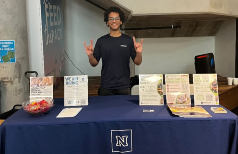 A person staffing a tabling event.