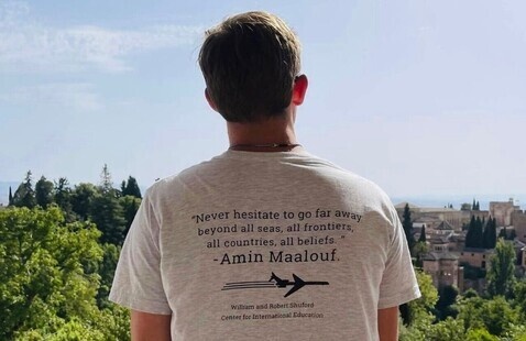 Student looks off in the distant landscape while studying abroad