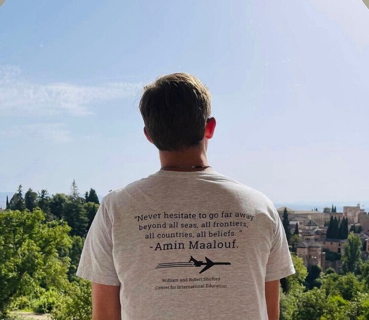 Student looks off in the distant landscape while studying abroad