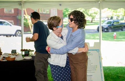 MHC staff members hug at Gratitude on the Green.