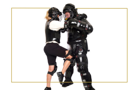 instructor teaching self defense techniques to trainee