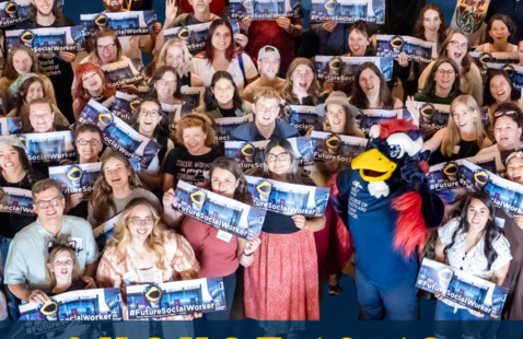 Social Work students posing with MSW Denver mascot Rowdy while holding up #FutureSocialWorker banners