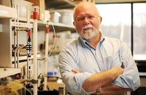 Russ Tracy standing in his lab