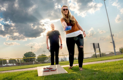 Photo of man and woman playing corn hole