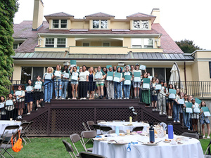 Fearless First students line up with President Holley along stairs and back deck of President's House.