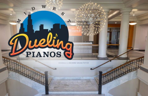 the front part of university hall with a dueling pianos logo