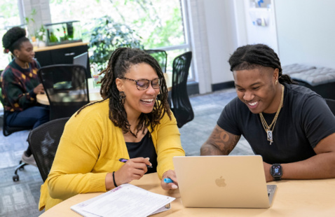 Staff member works with student in advising center