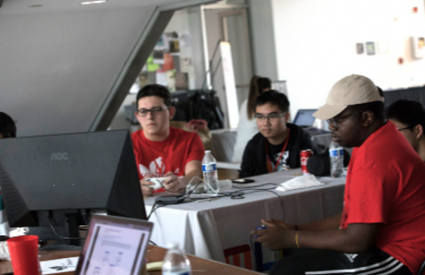 Students work together around a computer