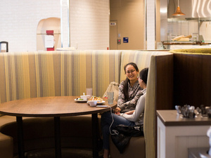 Students chatting in a round booth, Blanchard Dining Commons.