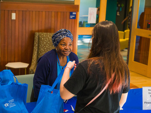 MCGI staff welcome and hand out swag to an international student.