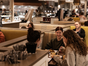Students eating at booths in the Dining Commons.