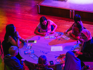 Students around a table playing a game.