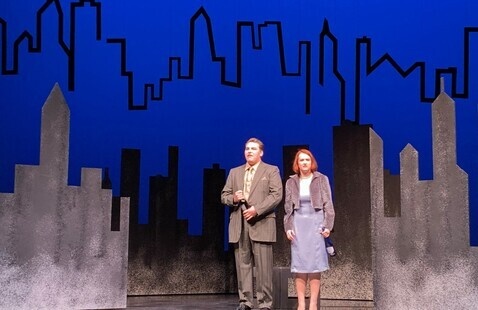 2 students on a stage performing