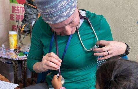 Study abroad students with child during health examination