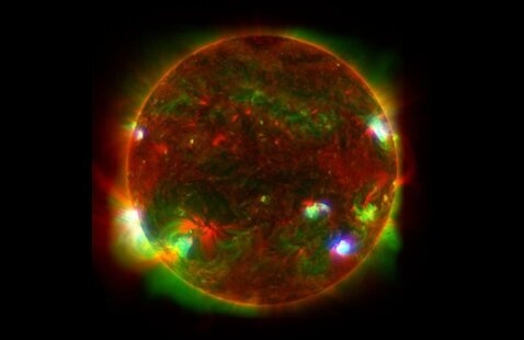 A spectroscopy image of the sun, marbled in red, green and blue.