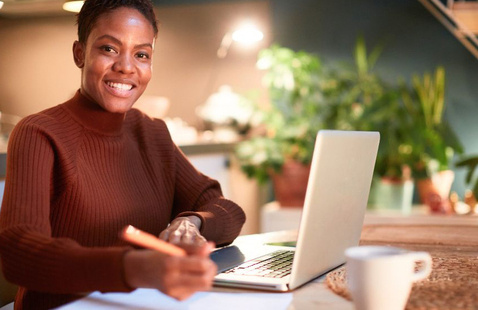 Smiling woman writing