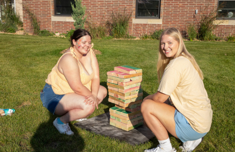 Two students playing Jenga.