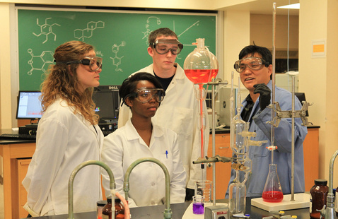 4 students together in a laboratory