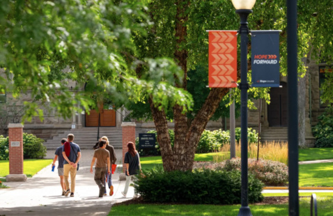 A tour group walks outside around campus.