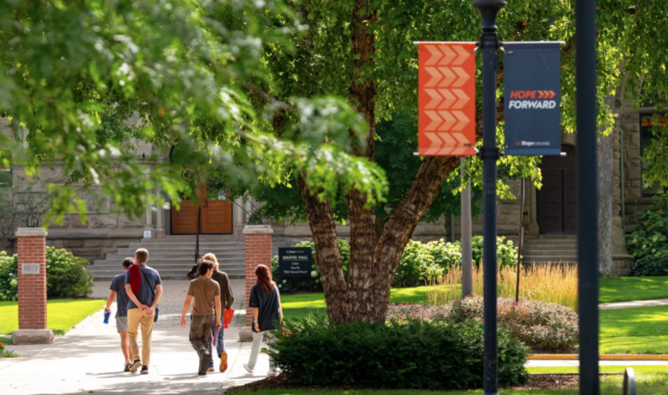 A tour group walks outside around campus.