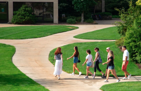A tour group walks outside around campus.