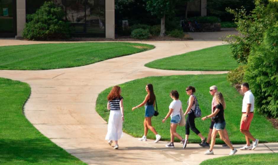 A tour group walks outside around campus.