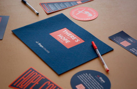 A collection of Hope Collection promotional materials on a table.