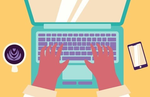 Person typing on a laptop with a coffee and phone nearby