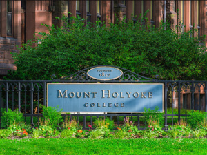 Mount Holyoke College sign with flowers in front.