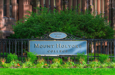 Mount Holyoke College sign with flowers in front.